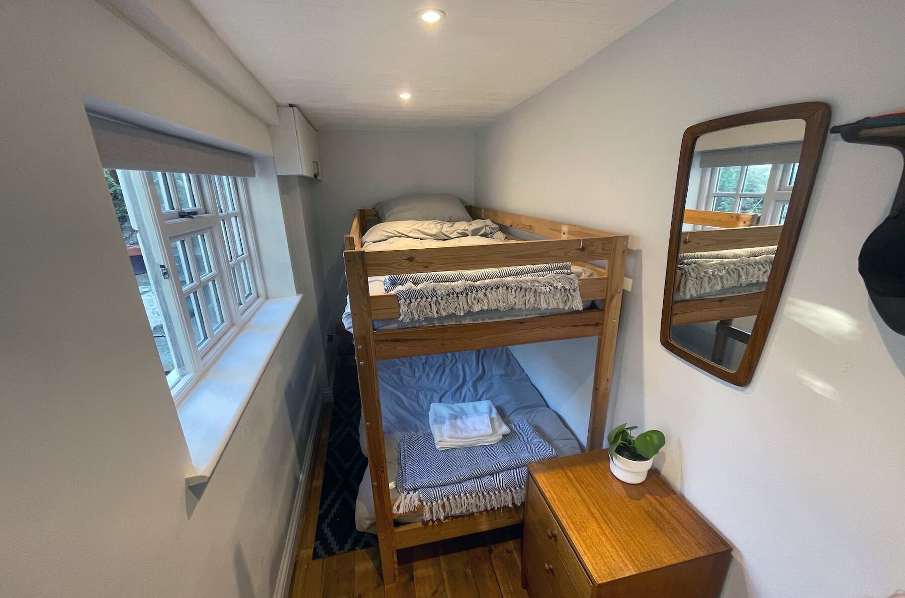 Bunk room with an adult-sized wooden bunk bed