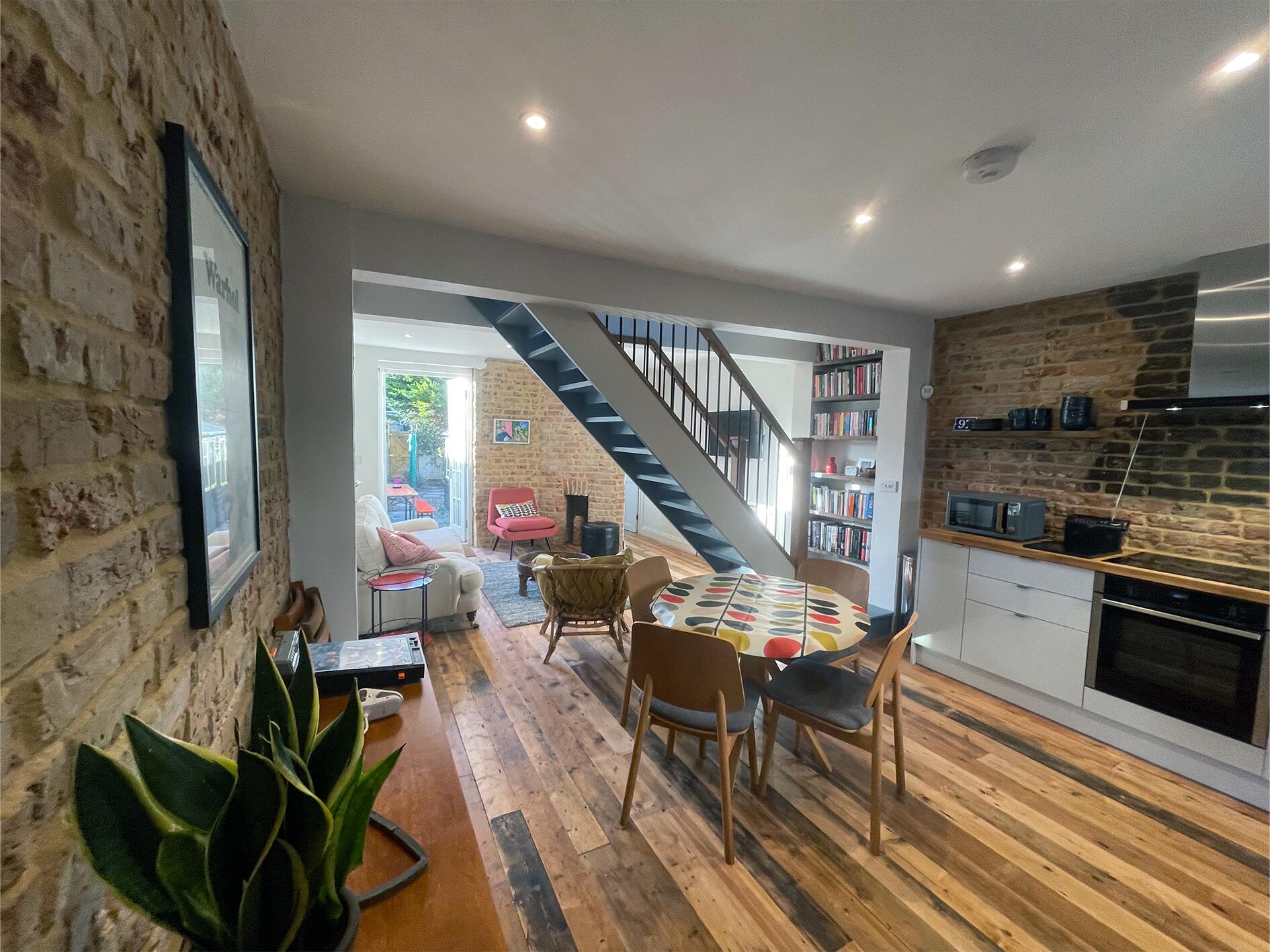 The full length of the ground floor, from sofa to garden doors