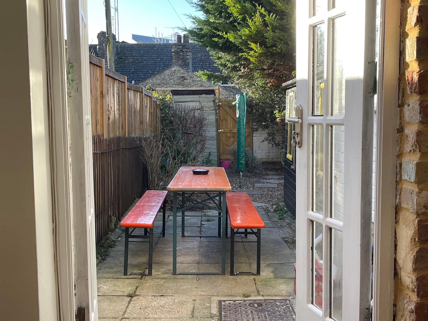 Garden patio with a long table and benches